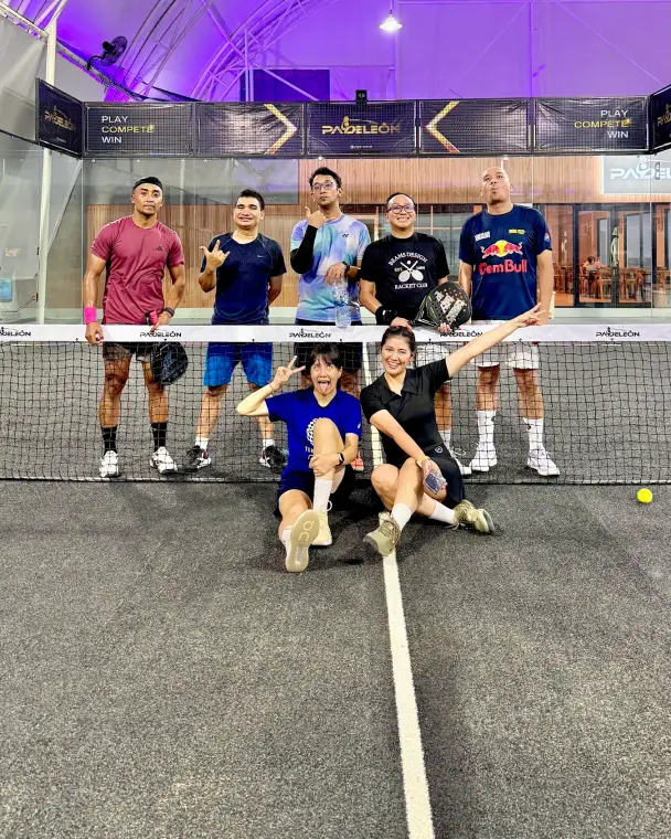 Players posing on the black court